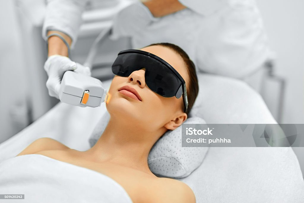 Skin Care. Face Beauty Treatment. IPL. Photo Facial Therapy. Ant Skin Care. Young Woman Receiving Facial Beauty Treatment, Removing Pigmentation At Cosmetic Clinic. Intense Pulsed Light Therapy. IPL. Rejuvenation, Photo Facial Therapy. Anti-aging Procedures. Laser Stock Photo