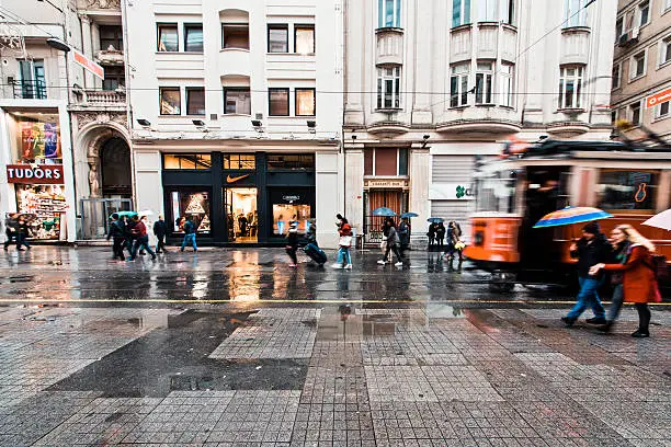 Istanbul, Turkey -November 28, 2015: Street car makes its way alongside shoppers crowding İstiklal Avenue. Known in English as Independence Avenue, the most famous shopping street in the country sees as many as three million pedestrians on a busy weekend day.