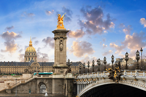 Pont Alexandre III and Les Invalides in Paris with a beautiful cloudscape