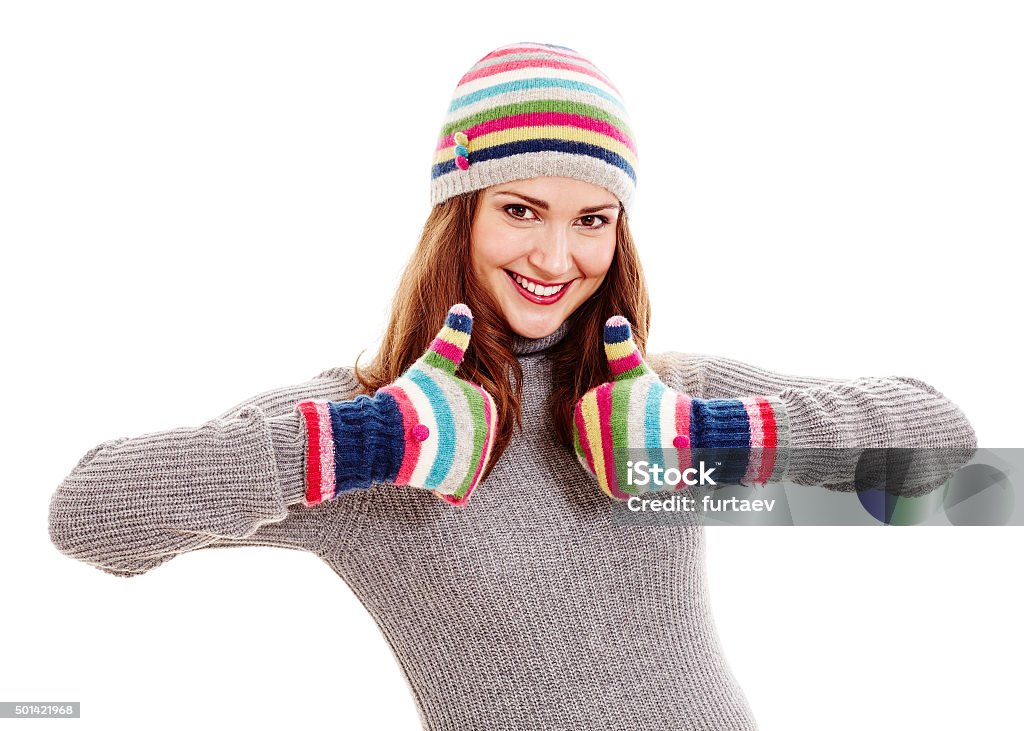 Woman in hat and mittens Young beautiful woman wearing warm autumn clothes - colorful hat and mittens, grey sweater - showing thumb up hand gesture with both hands and smiling isolated on white background - say no to cold and flu University Student Stock Photo