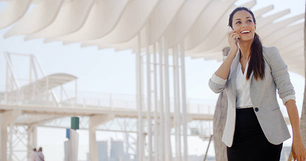 istock Gorgeous woman striding along chatting on a mobile 501422120