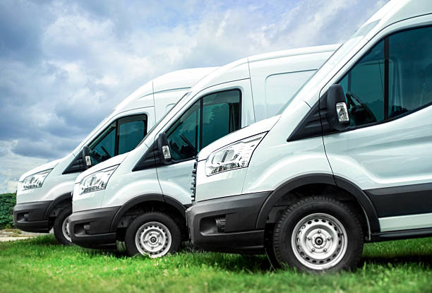 istock White vans in a row against blue sky 501422450
