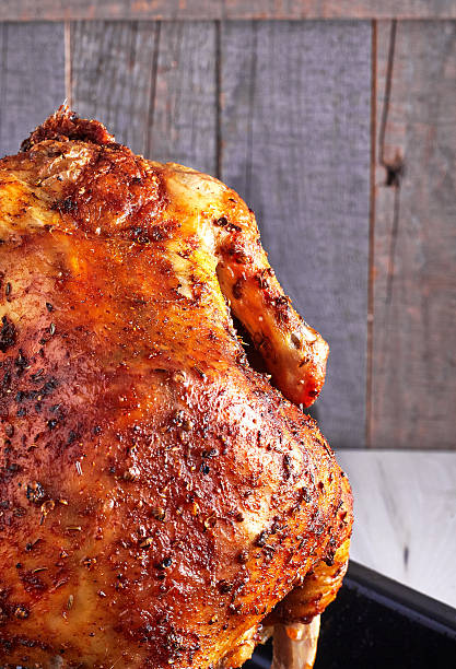 istock Whole roasted chicken on wooden background 501422484