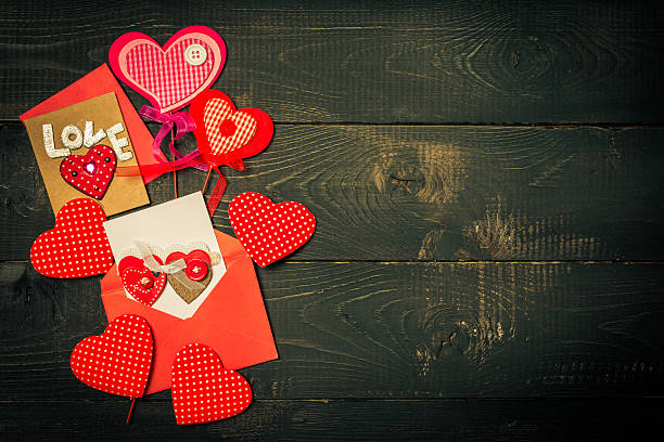 istock Love hearts on black wooden background 501423090