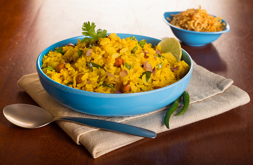 Poha is a widely eaten breakfast preparation, enjoyed all over India. It is basically flattened rice flakes tempered with Onions, Mustard seeds, Green Chillies, Peanuts, Curry leaves. It is often served with a slice of lime and sev ( savoury noodle like topping).