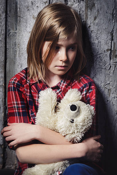 Depressed child with toy stock photo
