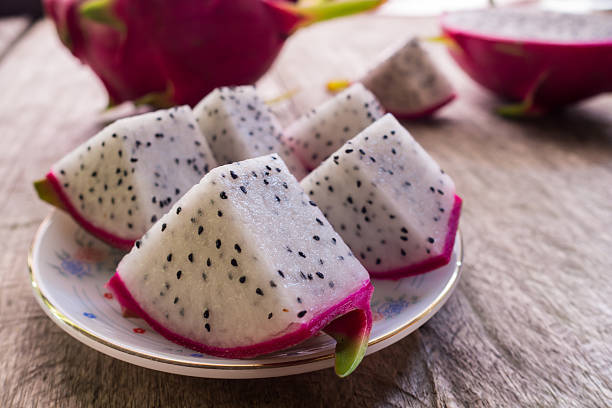 istock Dragon Fruit and some slice on old Wooden Table 501429098