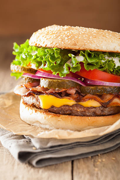 istock bacon cheese burger with pickles tomato onion 501431598