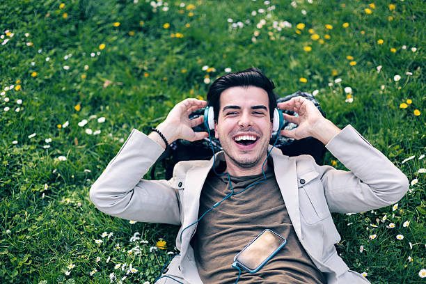 istock Young man with headphones roaring with laughter 501432080