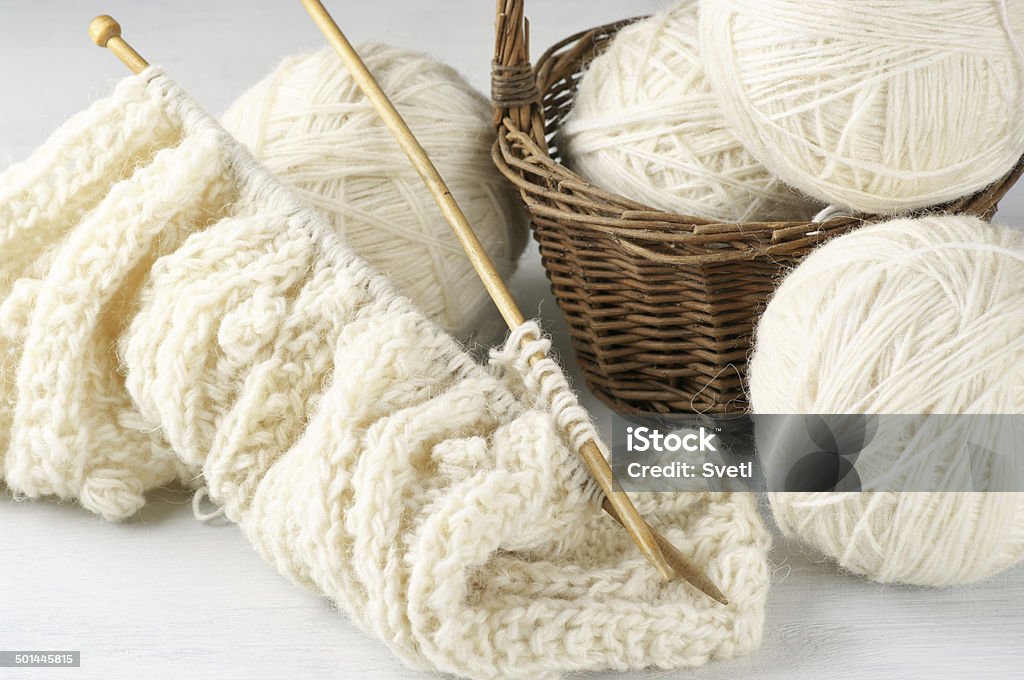 Knitting and yarn Natural woolen yarn and knitting on vintage wooden background. Art And Craft Stock Photo