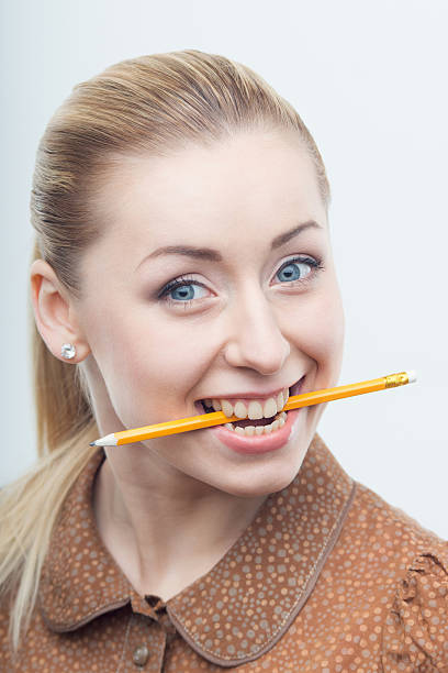 istock Excited attractive woman biting pencil 501446079