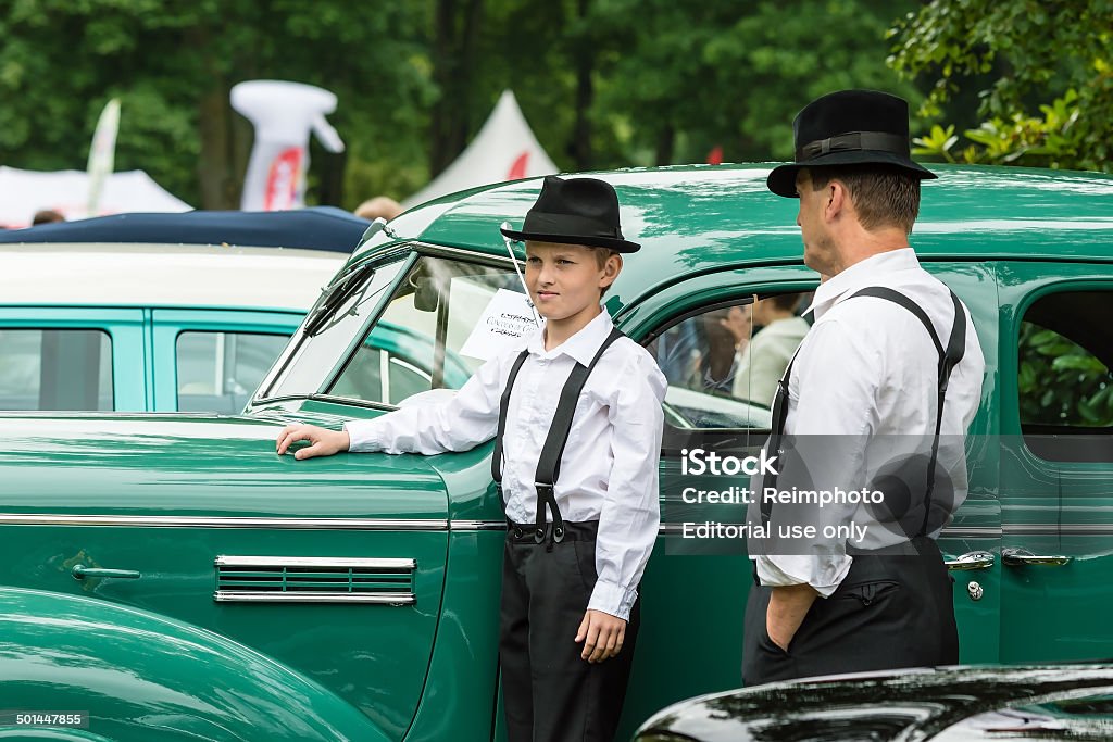 Winners of Concours de Charme Ronneby, Sweden - June 28, 2014: Nostalgia Festival, classic cars, motorcycles, fashion and entertainment. Winners of Concours de Charme 2014 with a green Plymouth Touring deluxe sedan 1939, Kent Tornqvist. 1939 Stock Photo