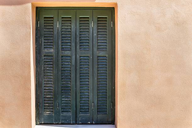 istock wooden shutter of blinds at a window and plastered wall 501454070