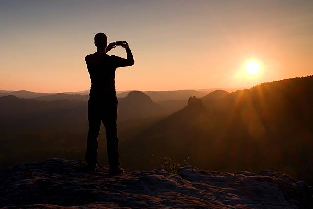 istock Hiker take photo by smart phone on mountain at sunrise. 501456566