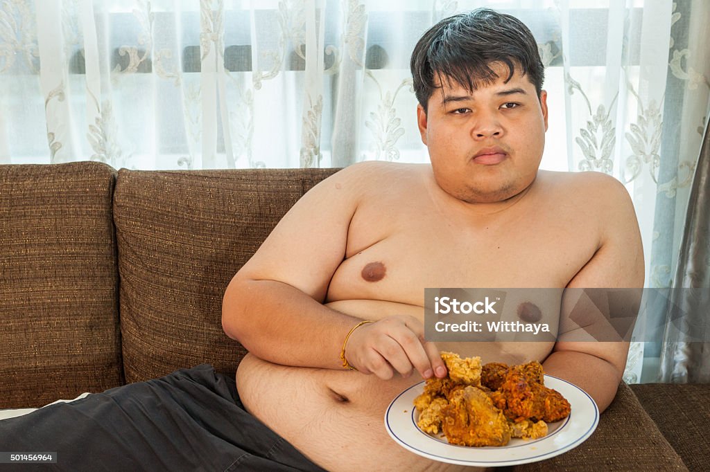 Asian a man eating fried chicken Fried Chicken Stock Photo