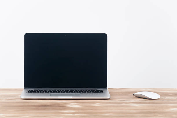Apple MacBook Pro.with Apple magic mouse 2 on table. stock photo