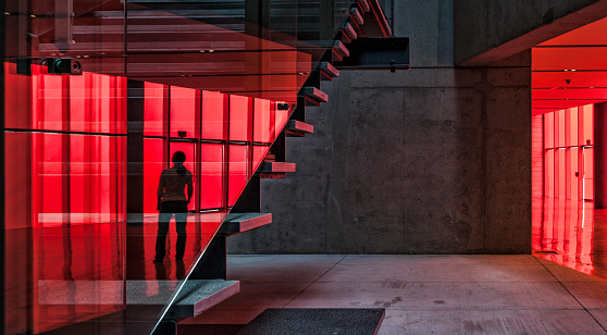 Red Reflection on staircase of woman City Hall in Seattle. 