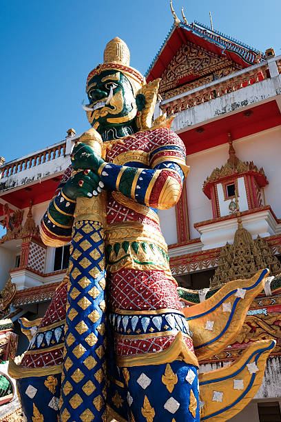 istock Green giant statue guarding Thai temple 501462442