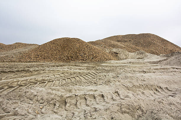 Gravel and sand Tire tracks in the sand and gravel hills. building sand stock pictures, royalty-free photos & images
