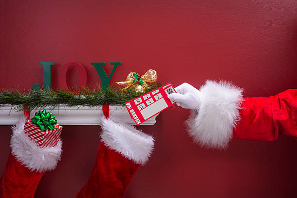 istock Santa's hand placing Blank tickets into Christmas Stockings 501467300