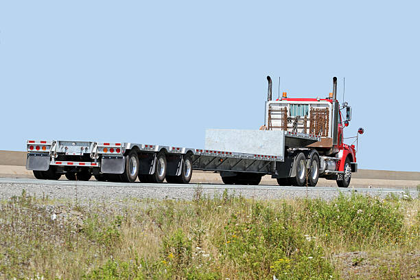 istock Semi Flatbed Trailer Truck With No Load Travelling Divided Highway 501467742