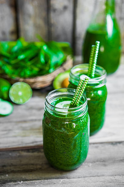 istock Green smoothie on rustic wooden background 501467912