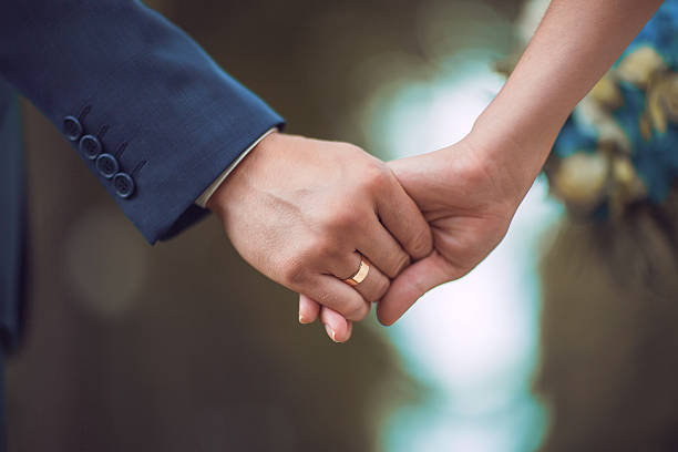 istock couple holding hands outdoors 501477122