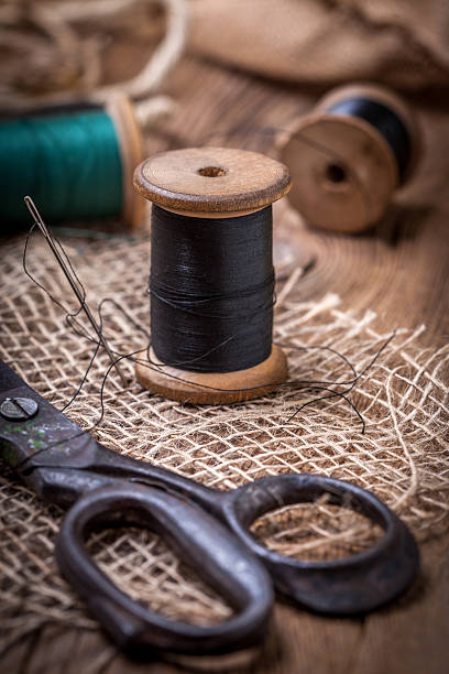 istock Old sewing kit on the wooden table. 501477176