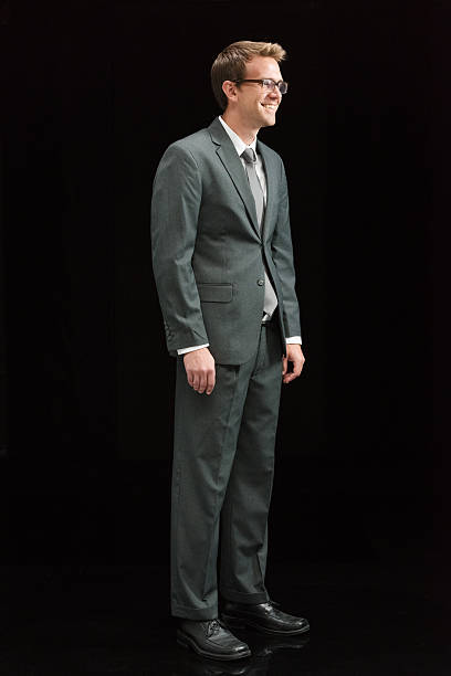 istock Smiling businessman standing and looking away 501477668