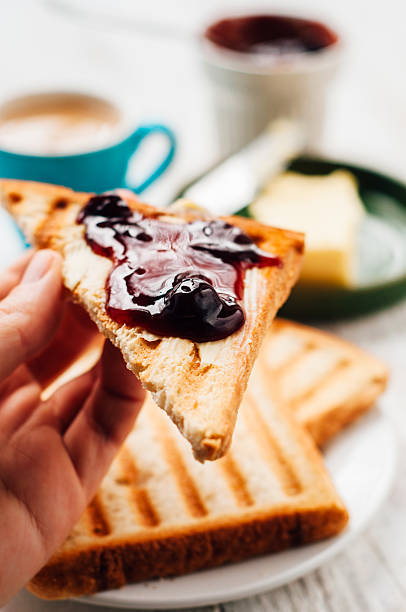istock Woman hand eating toast for breakfast 501478042