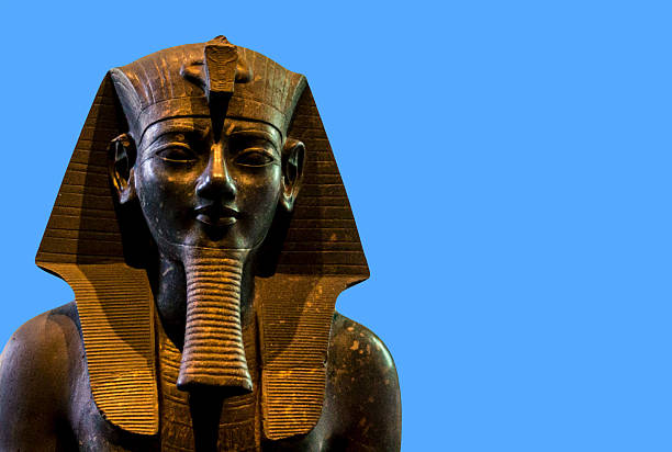 Statue of Amenhotep III or  Amenophis III isolated on blue background. stock photo
