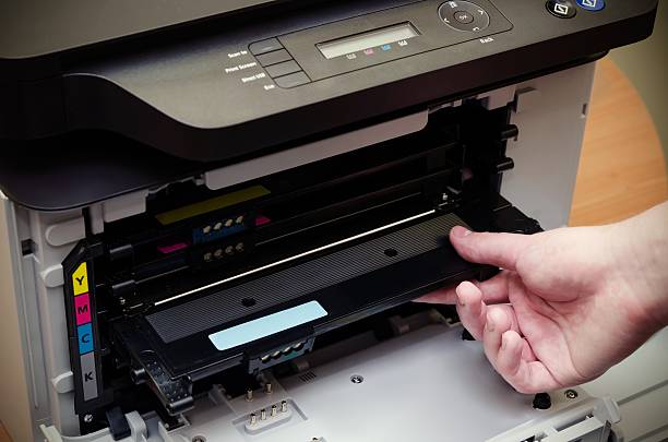 istock Man hand puts toner in the printer 501479584