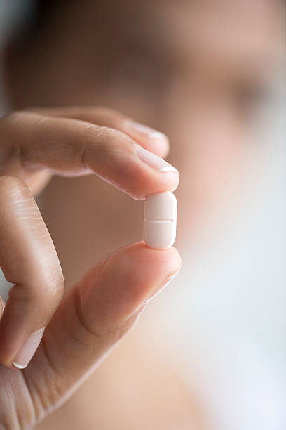 istock Woman Holding And Showing Medication Capsule 501481880