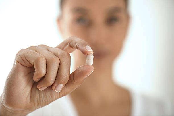 istock Woman Holding And Showing Medication Capsule 501482108