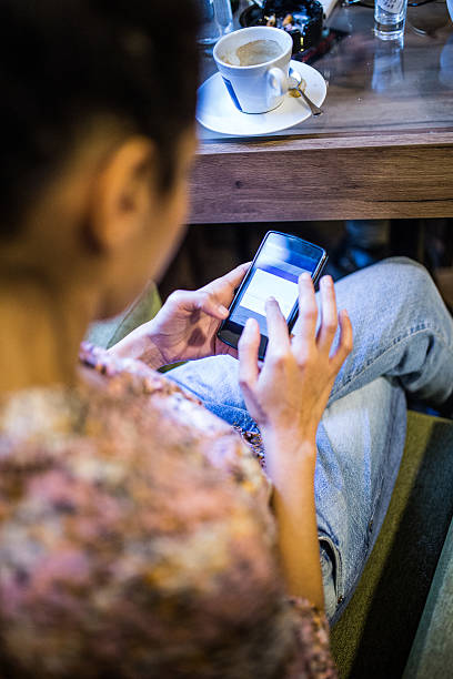 istock Girl using phone in the caffee 501483446