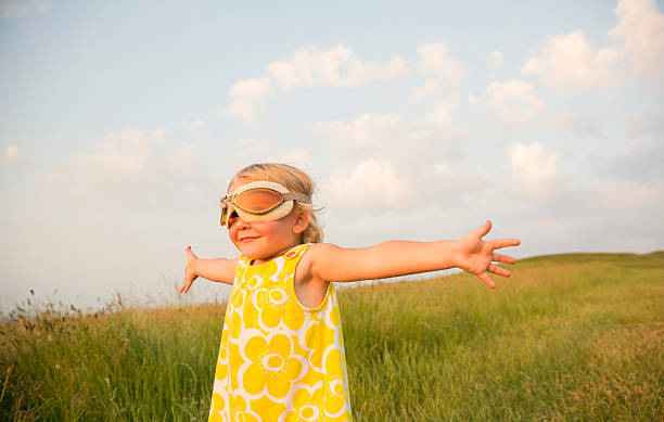 Young Girl with Outstretched Arms Imagines Flying