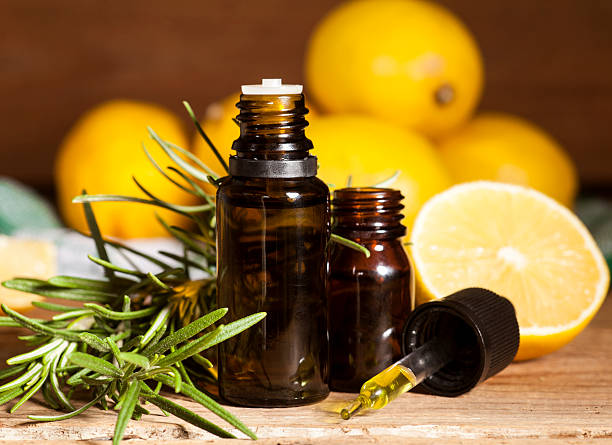 Lemon essential oil and rosemary stock photo