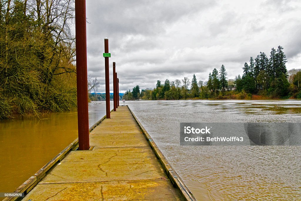 High Water on Willamette River This is the December 2015 view of the rising Willamette River after weeks of torrential rain. In the summertime you can find people fishing from this pier or just enjoying this tranquil location.  Oregon - US State Stock Photo