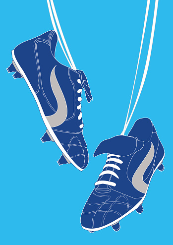 Blue football shoes on light blue background.