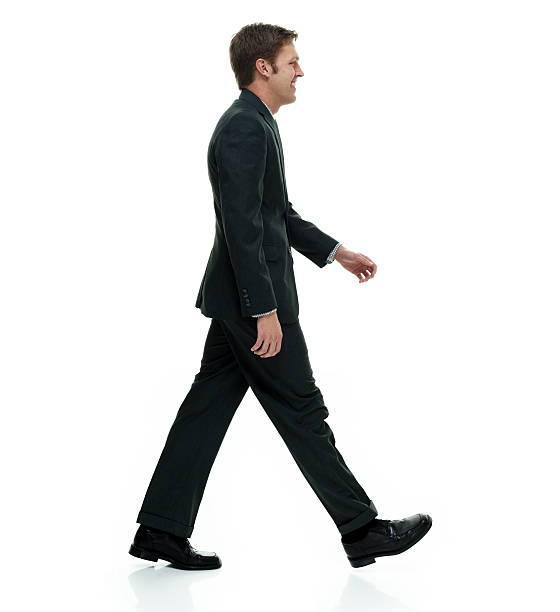 istock Smiling businessman walking and looking away 501504286