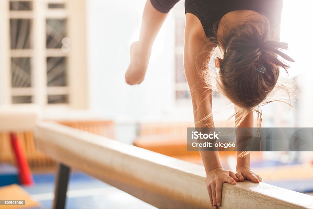 teen girl in a sports hall Girl gymnast trains in the gym Gymnastics Stock Photo