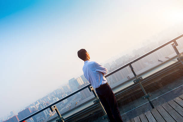 istock Businessman standing and looking city 501508486