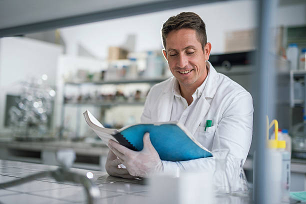 istock Smiling chemist reading medical data in laboratory. 501508606