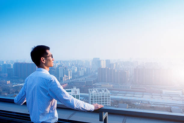 istock Businessman standing and looking city 501508700