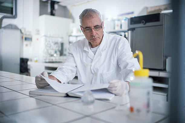 istock Senior forensic scientist reading medical data in laboratory. 501508780