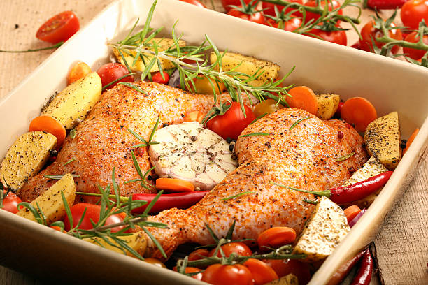 istock Chicken legs with vegetables and herbs ready for roasting 501509570
