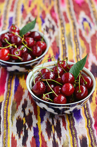 istock Ripe cherry in oriental tea bowls on pattern ethnic fabric 501509875