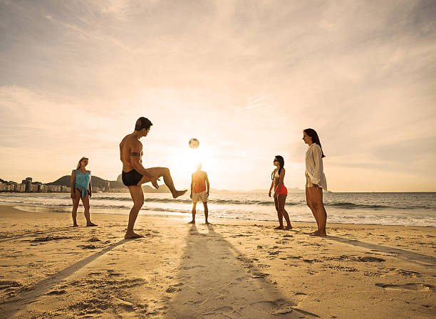 istock Young friends playing soccer on the beach at sunset. 501509994
