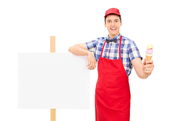 istock Ice cream seller standing by a blank signboard 501510285