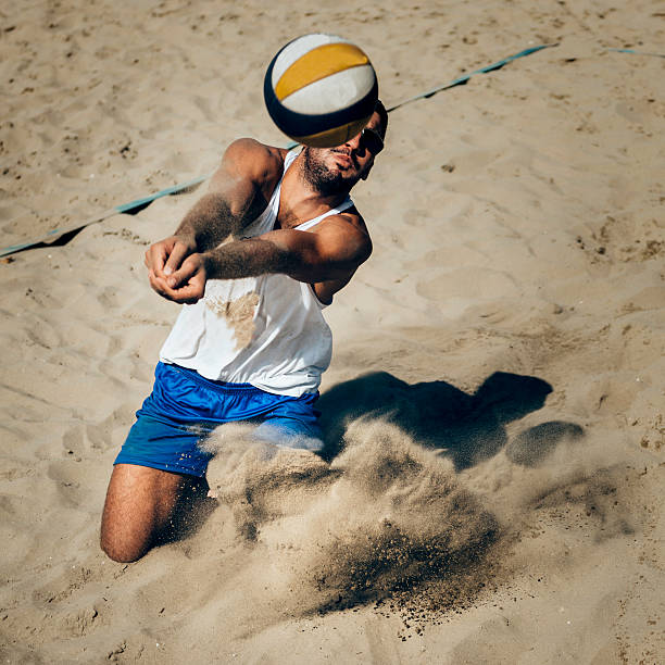 Beach volleyball dig Beach volleyball dig beach volleyball stock pictures, royalty-free photos & images